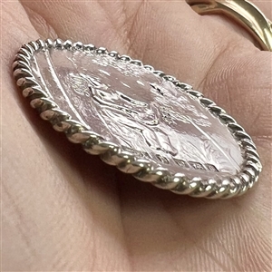Hallmarked silver button of man playing an instrument in a garden.