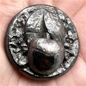 Metalized molded plastic button of a cherry.