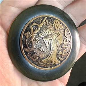 Vintage plastic button with brass of an Asian woman with a fan.