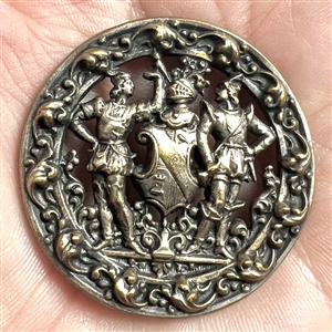 Brass button of two supporters and a shield and helm.