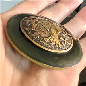 Vintage plastic button with brass of an Asian woman with a fan.