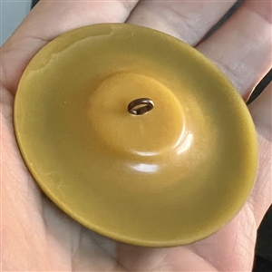 Vintage plastic button with brass of an Asian woman with a fan.
