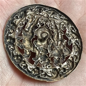 Brass button of two supporters and a shield and helm.