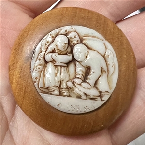A 19th c. Wood button with a molded glass insert of Asian men.