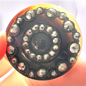 A 19th c. Natural horn button with steels.