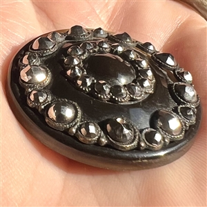 A 19th c. Natural horn button with steels.