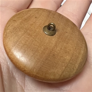 A 19th c. Wood button with a molded glass insert of Asian men.