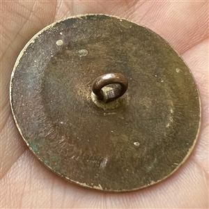 An 18th c. chased copper Colonial target button.