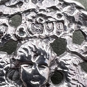 Two hallmarked silver buttons of heads.