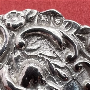 Two silver buttons of cherubs. 