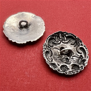 Two silver buttons of cherubs. 
