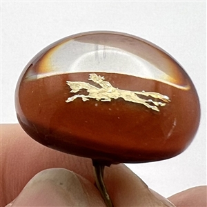 John Gooderham red paperweight with gold foil horse and rider glass studio button.
