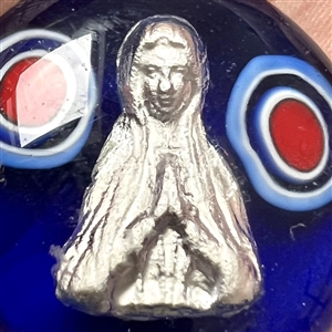 Glass studio paperweight button with sulphide by Theresa Rarig.