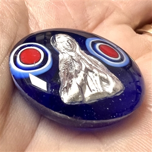 Glass studio paperweight button with sulphide by Theresa Rarig.
