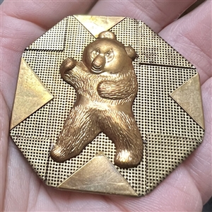 Handkerchief corner metal studio button of a bear by Phil Linley.