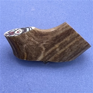 Studio button on antler with pilgrims.