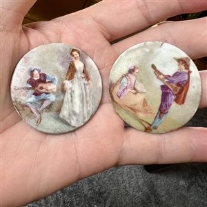 Two large ceramic buttons of women with musicians.