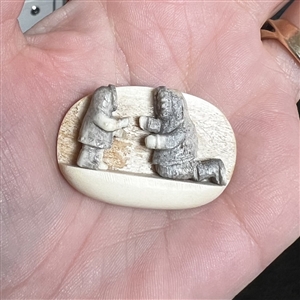 Scarce! Carved natural material studio button of an Eskimo adult and child.