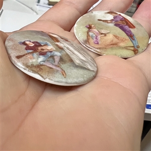 Two large ceramic buttons of women with musicians.