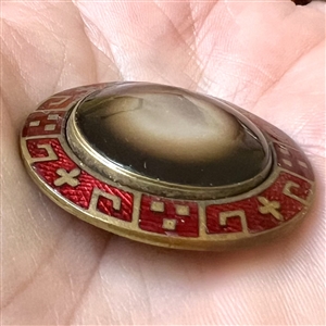 Glass in metal button with an unusual enamel border.