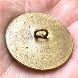 Glass in metal button with an unusual enamel border.