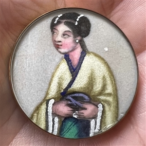 Painting on fabric button of an Asian woman.