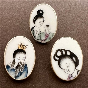 Three shard ceramic buttons of Asians, mostly children.