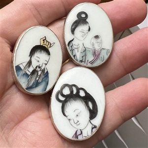 Three shard ceramic buttons of Asians, mostly children.