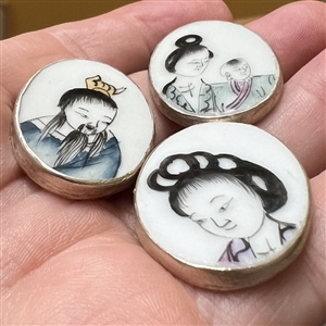 Three shard ceramic buttons of Asians, mostly children.