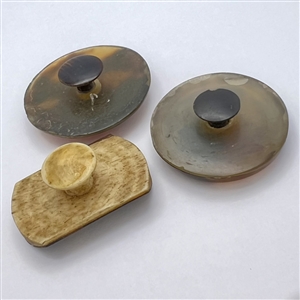 Three tortoise shell studs with inlay.