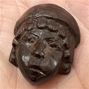 Wood realistic button of a European man’s head.