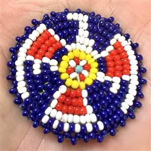 Native American beaded button of a thunderbird symbol.