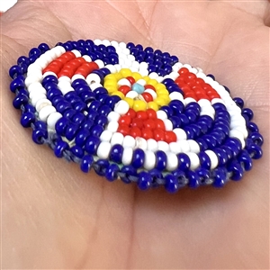 Native American beaded button of a thunderbird symbol.
