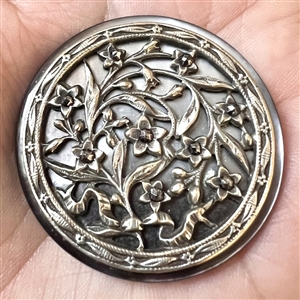 Victorian open work design of flowers over pearl button.