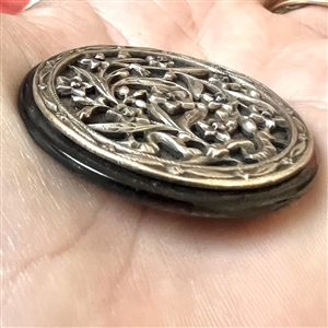 Victorian open work design of flowers over pearl button.