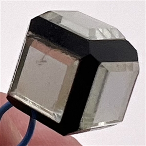 Black glass cube button with clear glass mirrored insets.