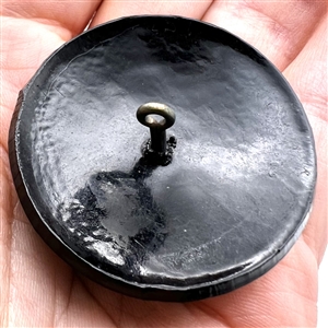 Brass thistle over plastic (?) button.