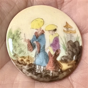 Glazed porcelain button of two Asian woman in garden setting.