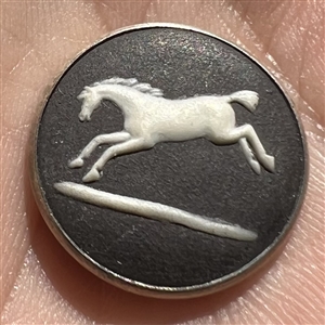 Wedgewood button of a jumping horse set in hallmarked silver.