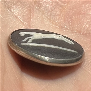 Wedgewood button of a jumping horse set in hallmarked silver.