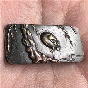 Japanese Shakudo button of a crane standing in a stream.