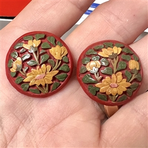 Two unusual multi-colored cinnabar buttons of flowers.