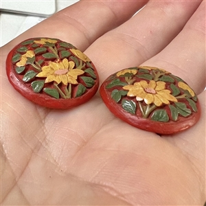 Two unusual multi-colored cinnabar buttons of flowers.
