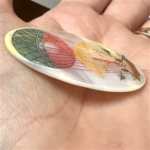 Incised pearl (?) button of a hot air balloon.