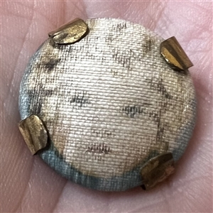 Vintage garter button of a young girl.