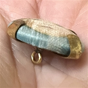 Vintage garter button of a young girl.