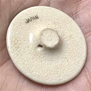 Japanese Satsuma button of sailboats on a lake.