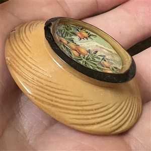 Bob Benson studio button of oranges.