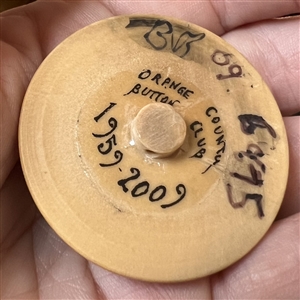 Bob Benson studio button of oranges.