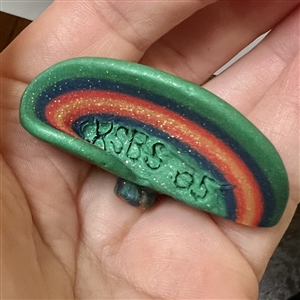 Sculpty clay studio button of a hat by Maria Kragh.